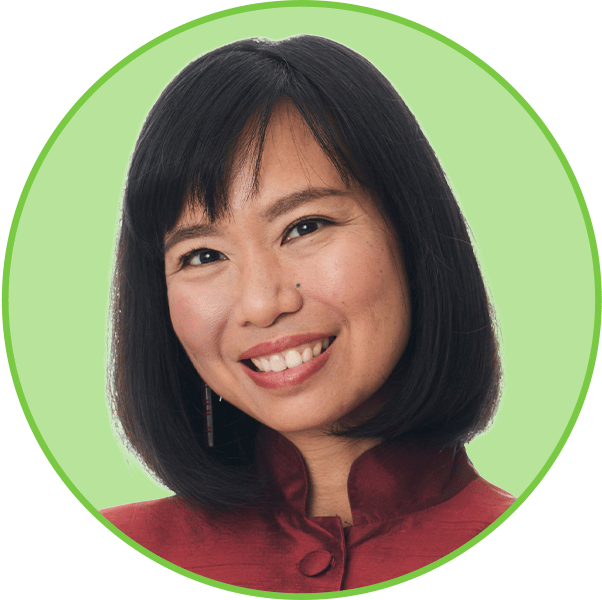 Smiling Asian woman with short dark hair and a red top, set against a green circular background.