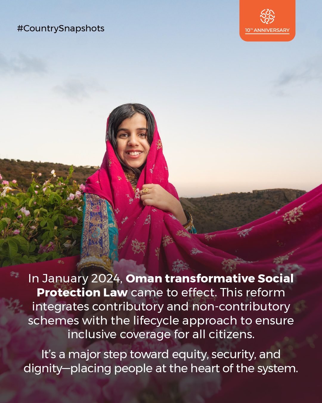 Smiling girl in pink Omani attire with text about Oman's new Social Protection Law.