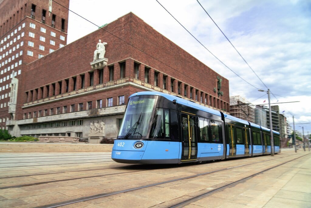 Sky, Cloud, Building, Train, Vehicle, Plant, Window, Wheel, Electricity, Rolling