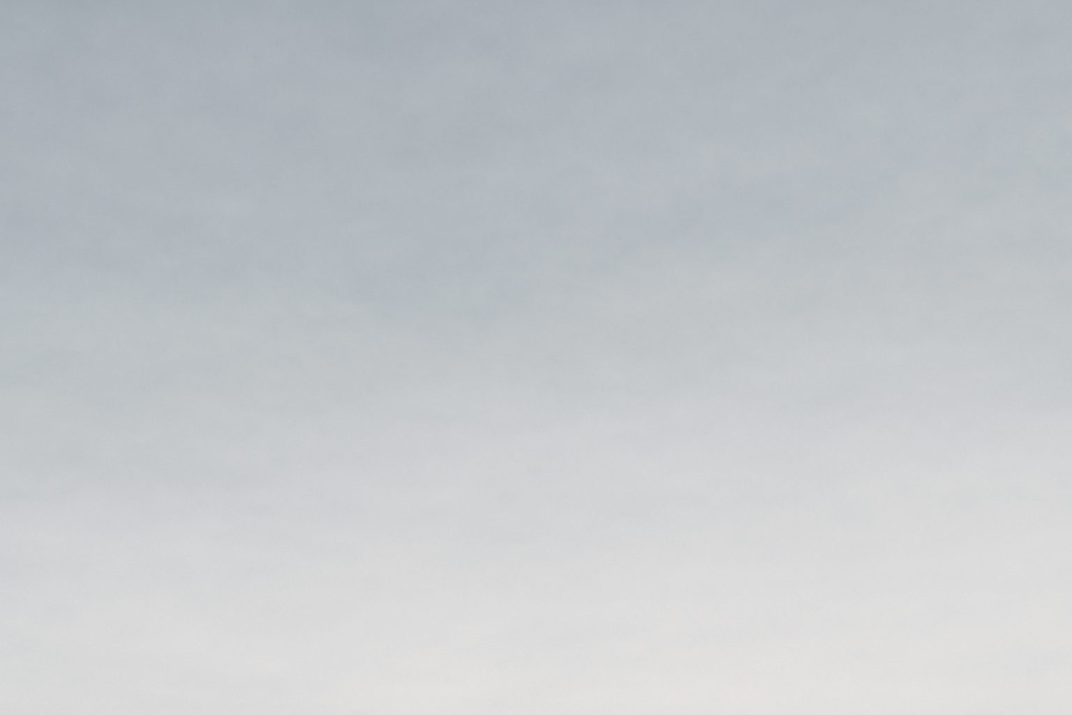 A soft gradient from light blue at the top to white at the bottom.