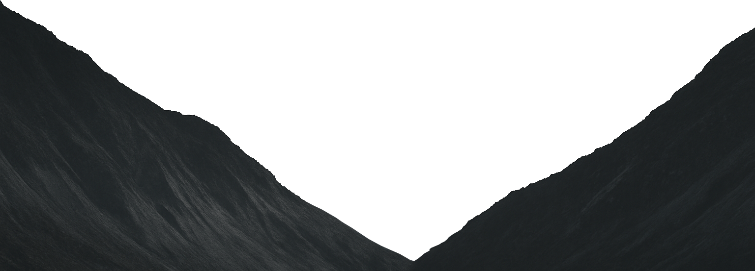 Dark, textured mountain slopes framing a green, V-shaped gap.