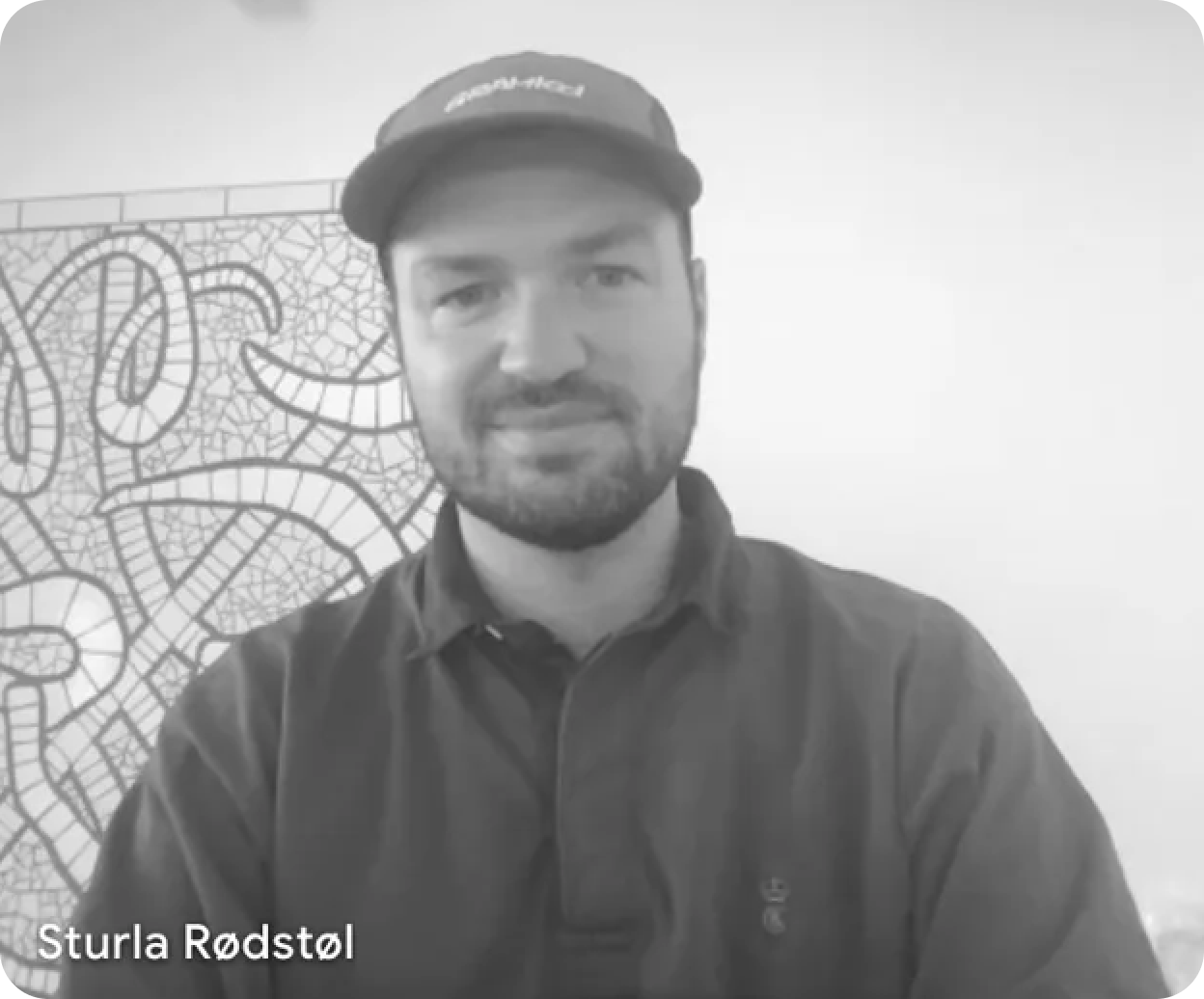 Grayscale portrait of Sturla Rødøl wearing a cap and smiling.