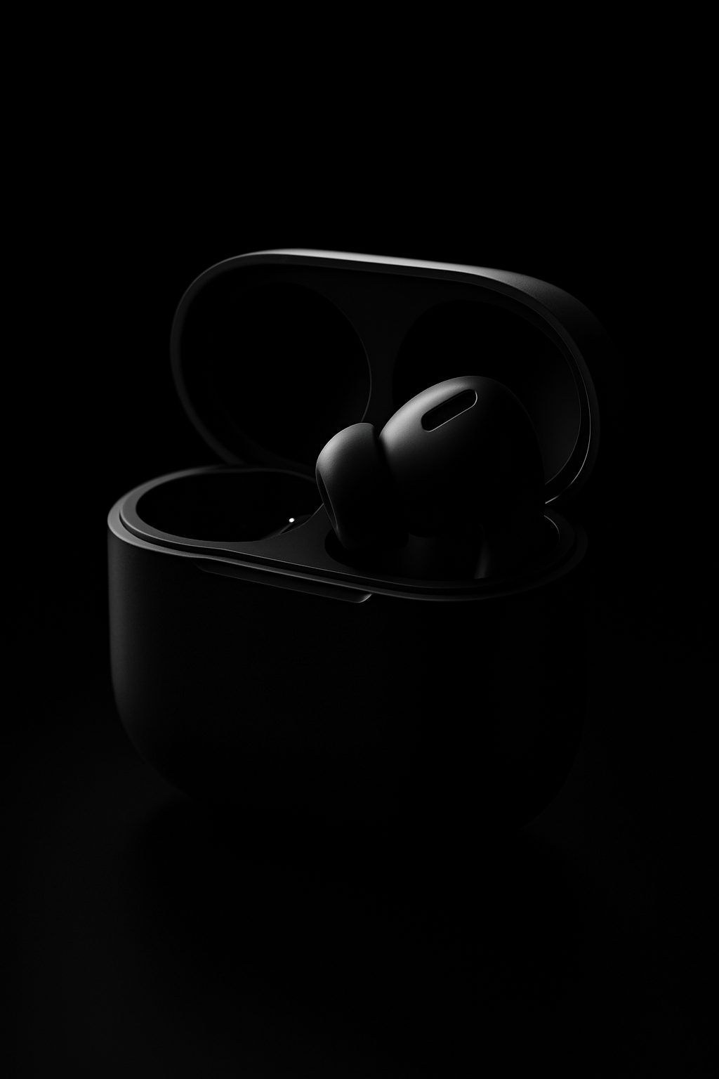 Black earbuds in an open charging case against a dark background with subtle lighting.