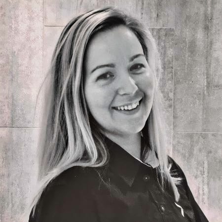BW portrait of a smiling woman with long hair.