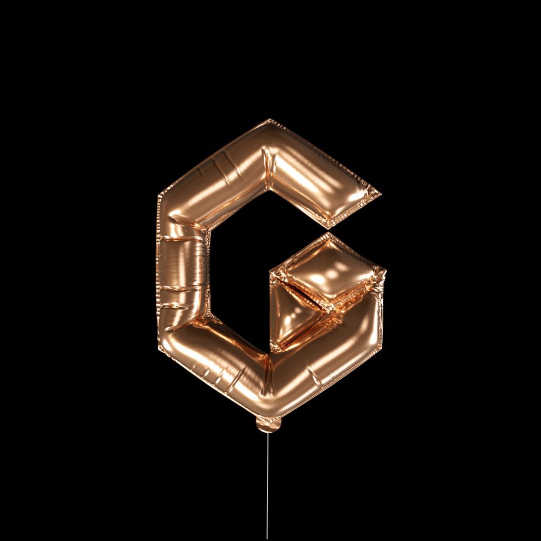 A gold foil balloon in the shape of a stylized G, against a black background.
