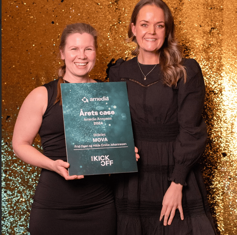 Two smiling women hold an Amedia "Case of the Year" award plaque.