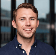 Smiling man with short brown hair.