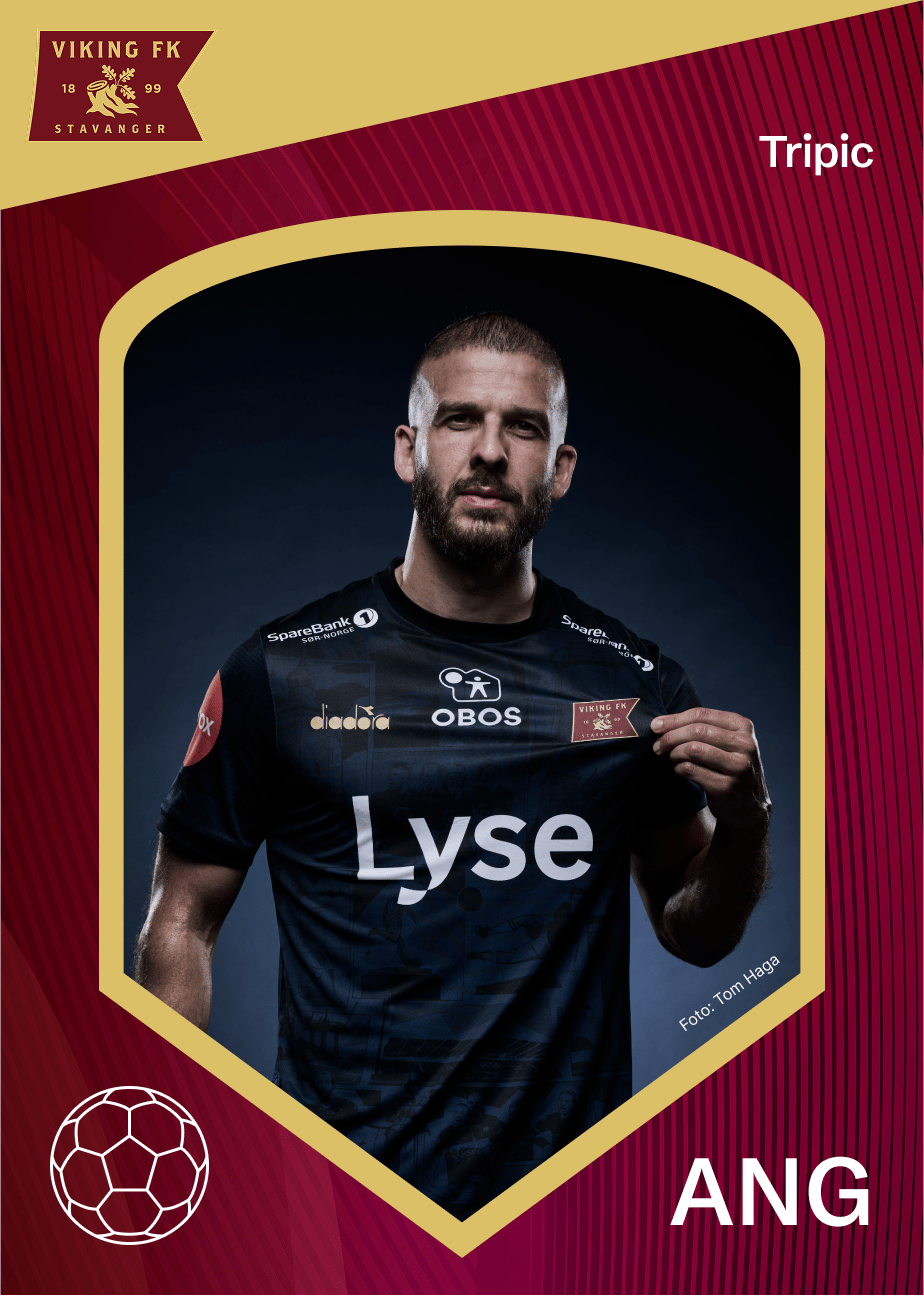 Football player Tripic in a dark Viking FK jersey, holding the club crest.