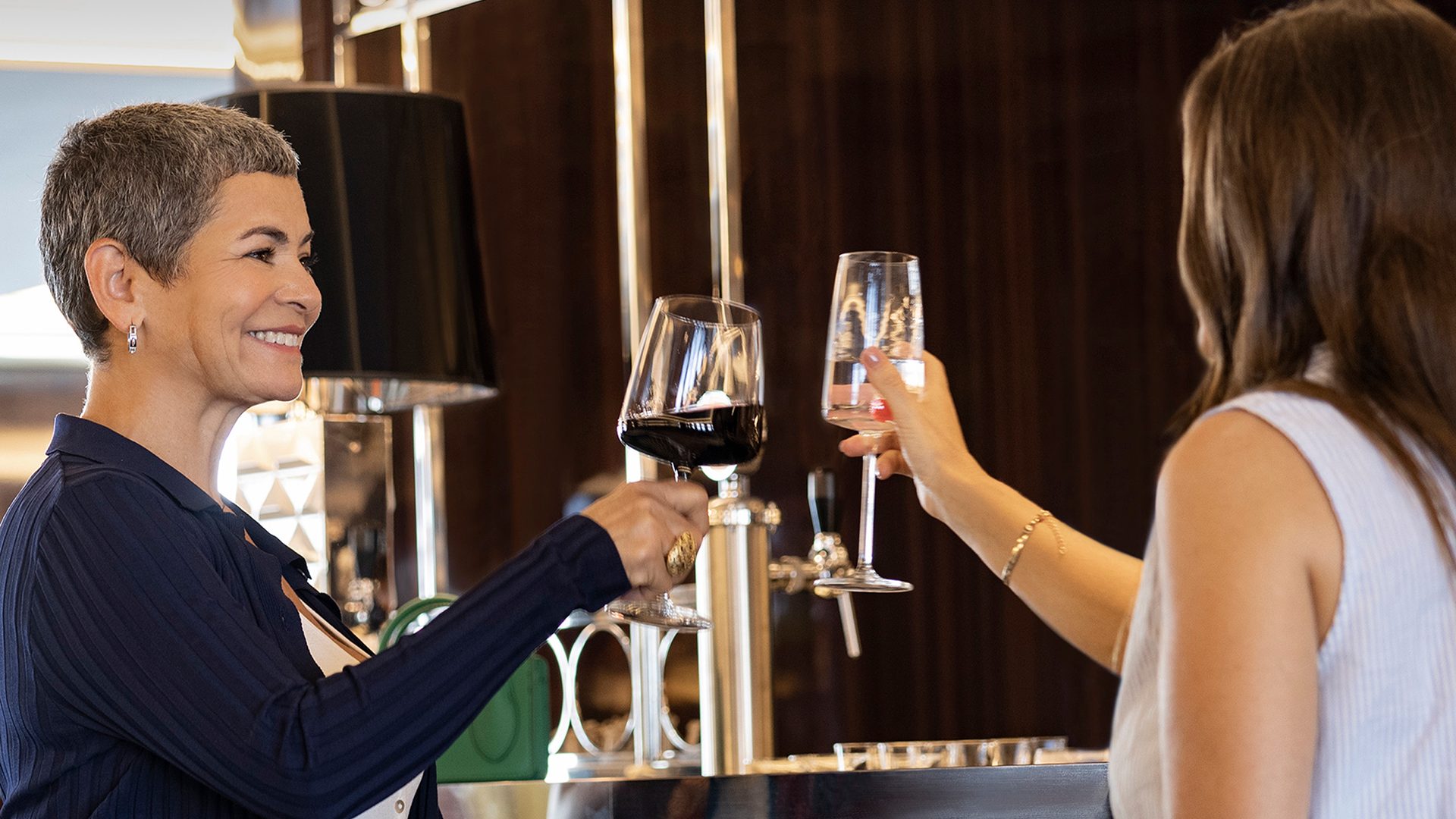 Wine glass, Alcoholic beverage, Tableware, Smile, Drinkware, Stemware, Barware, Gesture, Eyewear