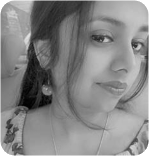 Close-up black and white portrait of a young woman with long hair and an earring, looking at the camera.