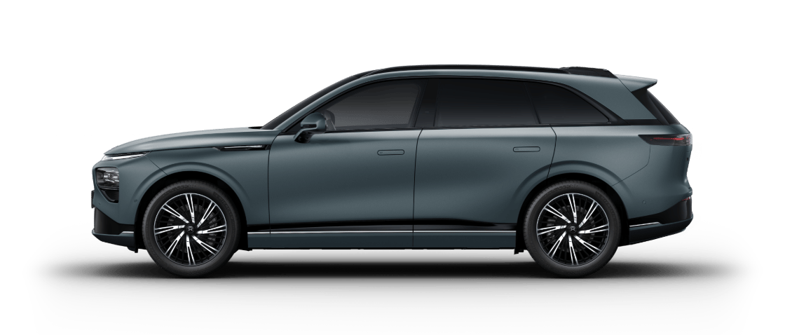 Side view of a dark grey modern SUV against a dark green background.