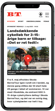 Smartphone displaying a Danish news article about a children's cycling race, featuring a video of a boy.