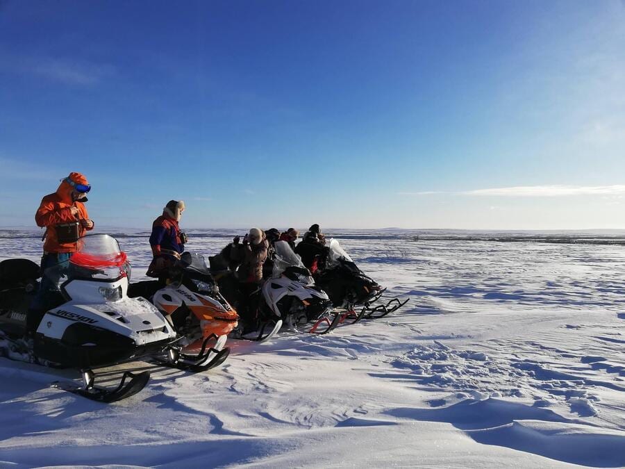Automotive tire, Outdoor recreation, Ice cap, Sky, Snowmobile, Snow, Cloud, Vehicle, Helmet