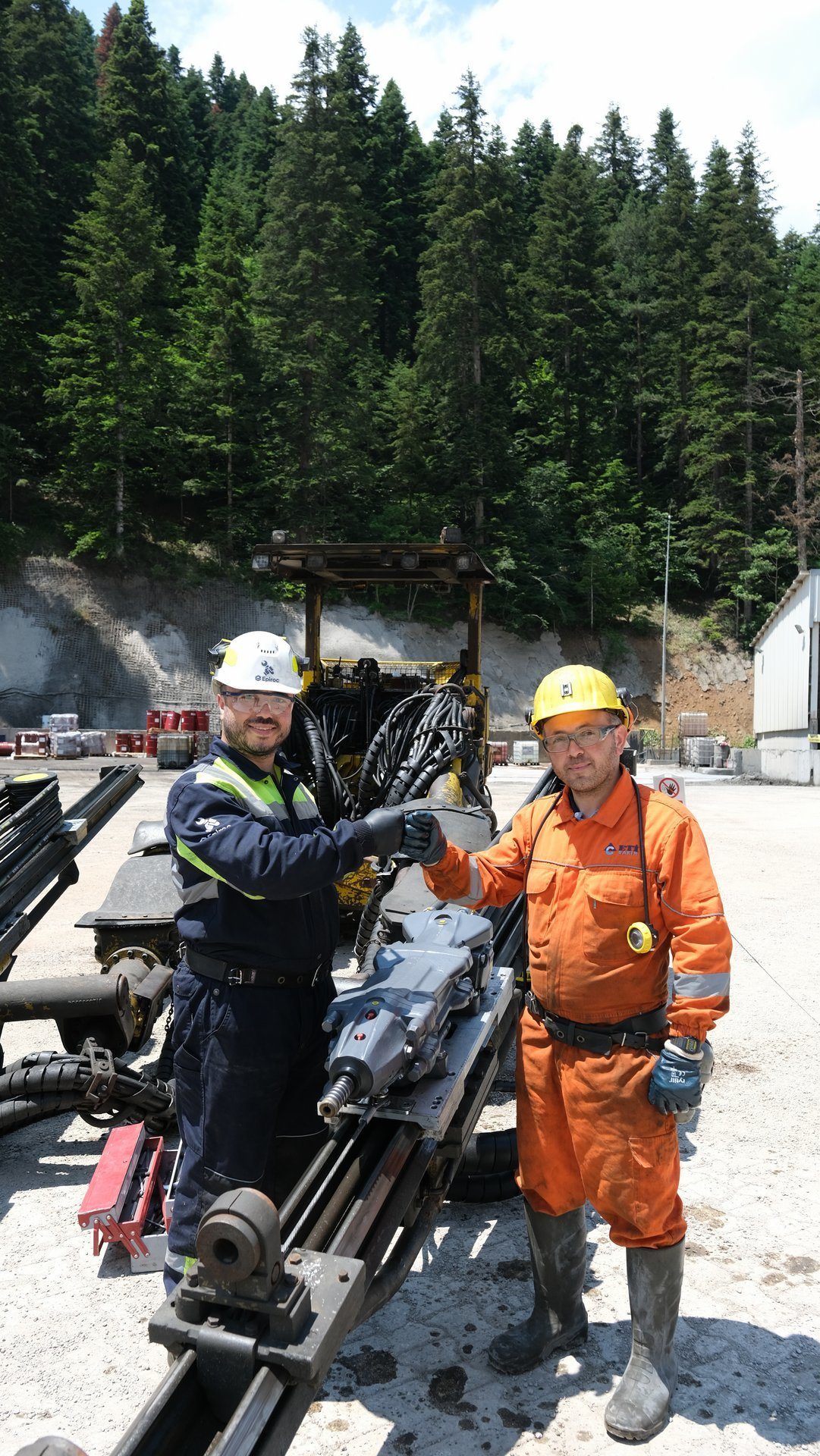 Motor vehicle, Hard hat, Wheel, Tire, Plant, Helmet, Tree, Workwear, Asphalt