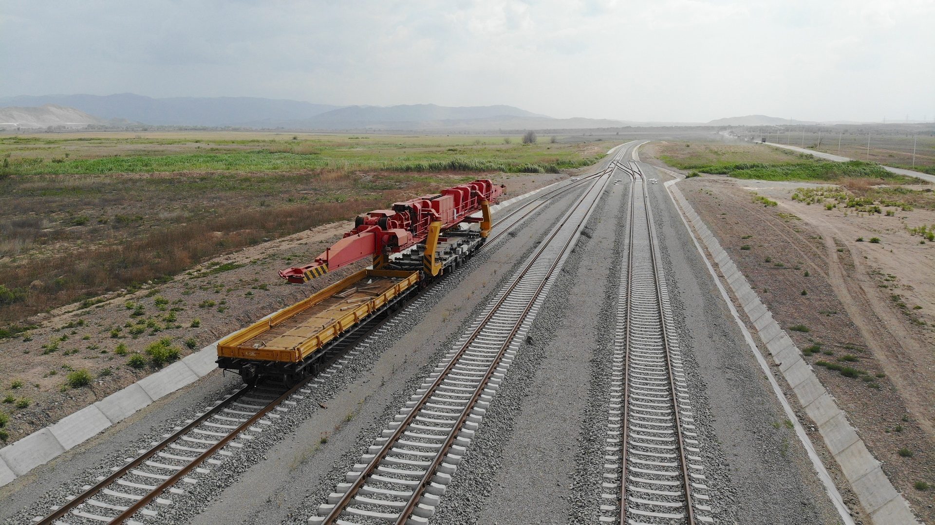 Mode of transport, Road surface, Rolling stock, Sky, Cloud, Train, Asphalt, Vehicle, Track, Railway