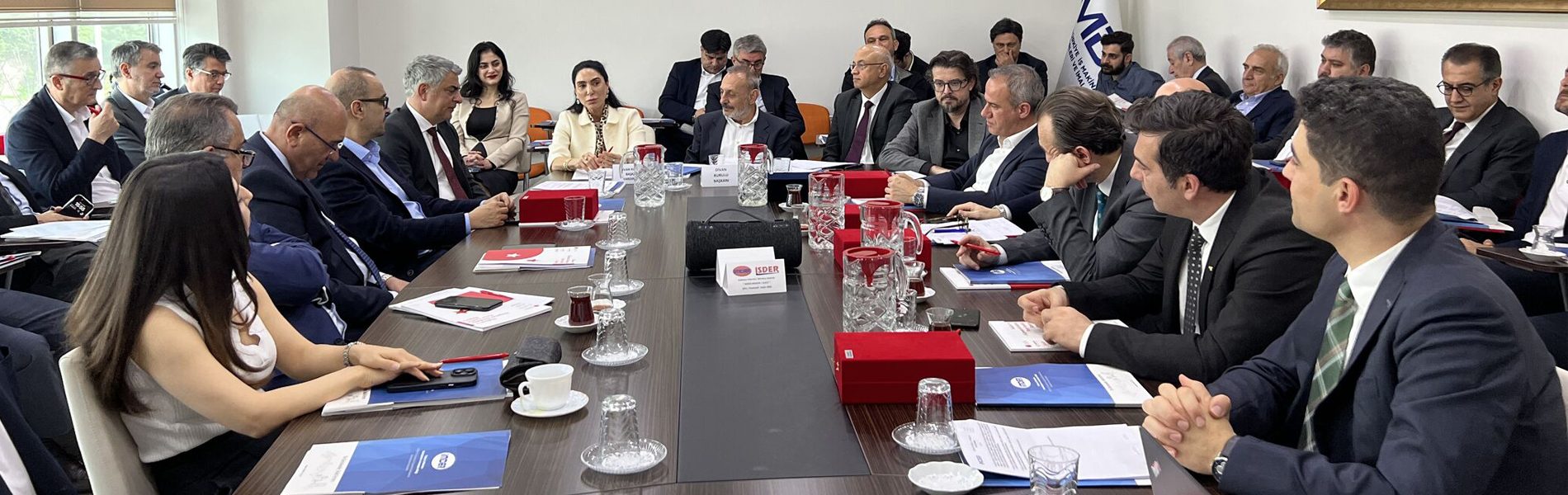 Conference room table, Tableware, Coat, Human, Chair, Suit, Water