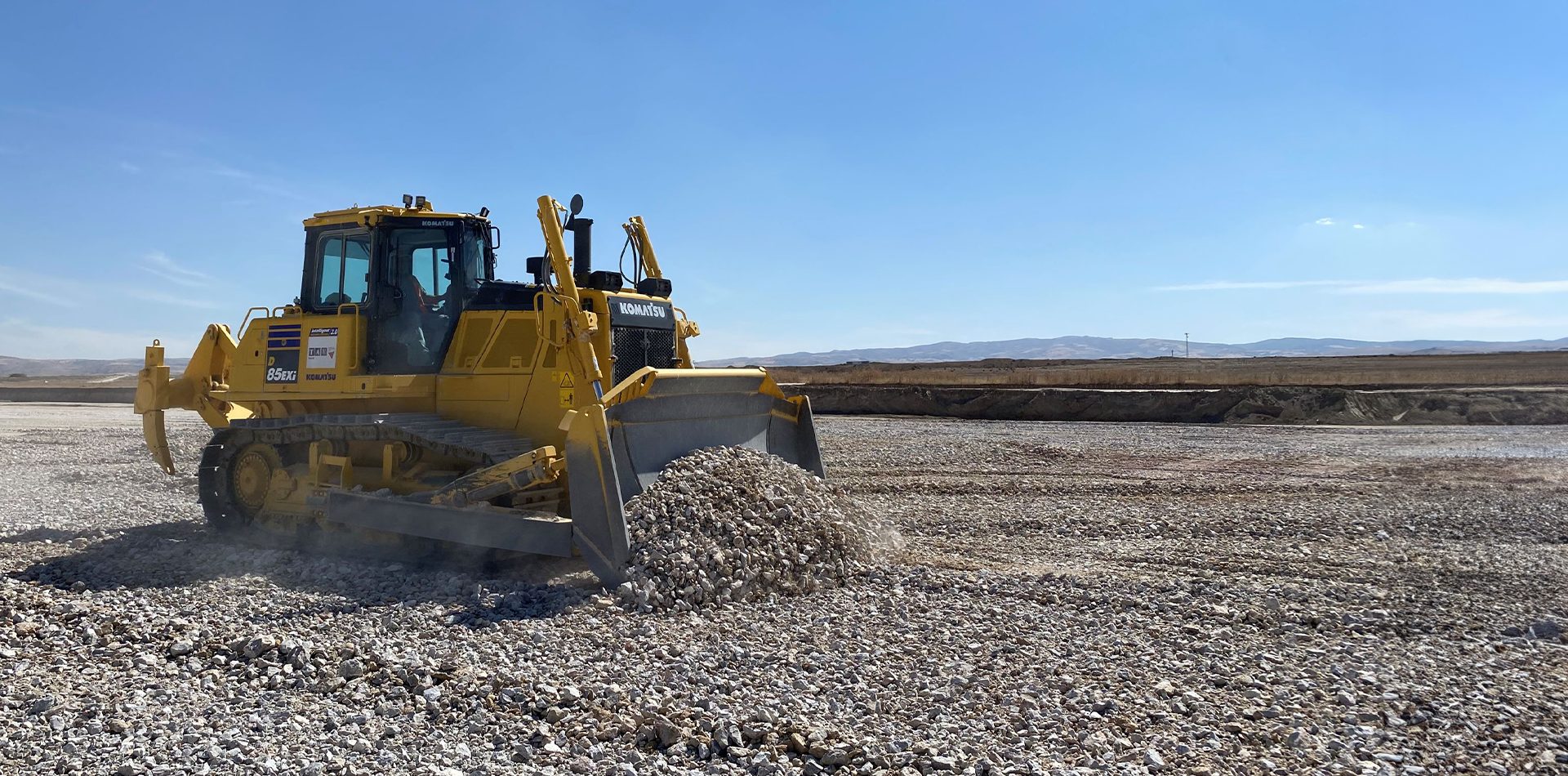 Road surface, Automotive tire, Sky, Vehicle, Asphalt, Bulldozer