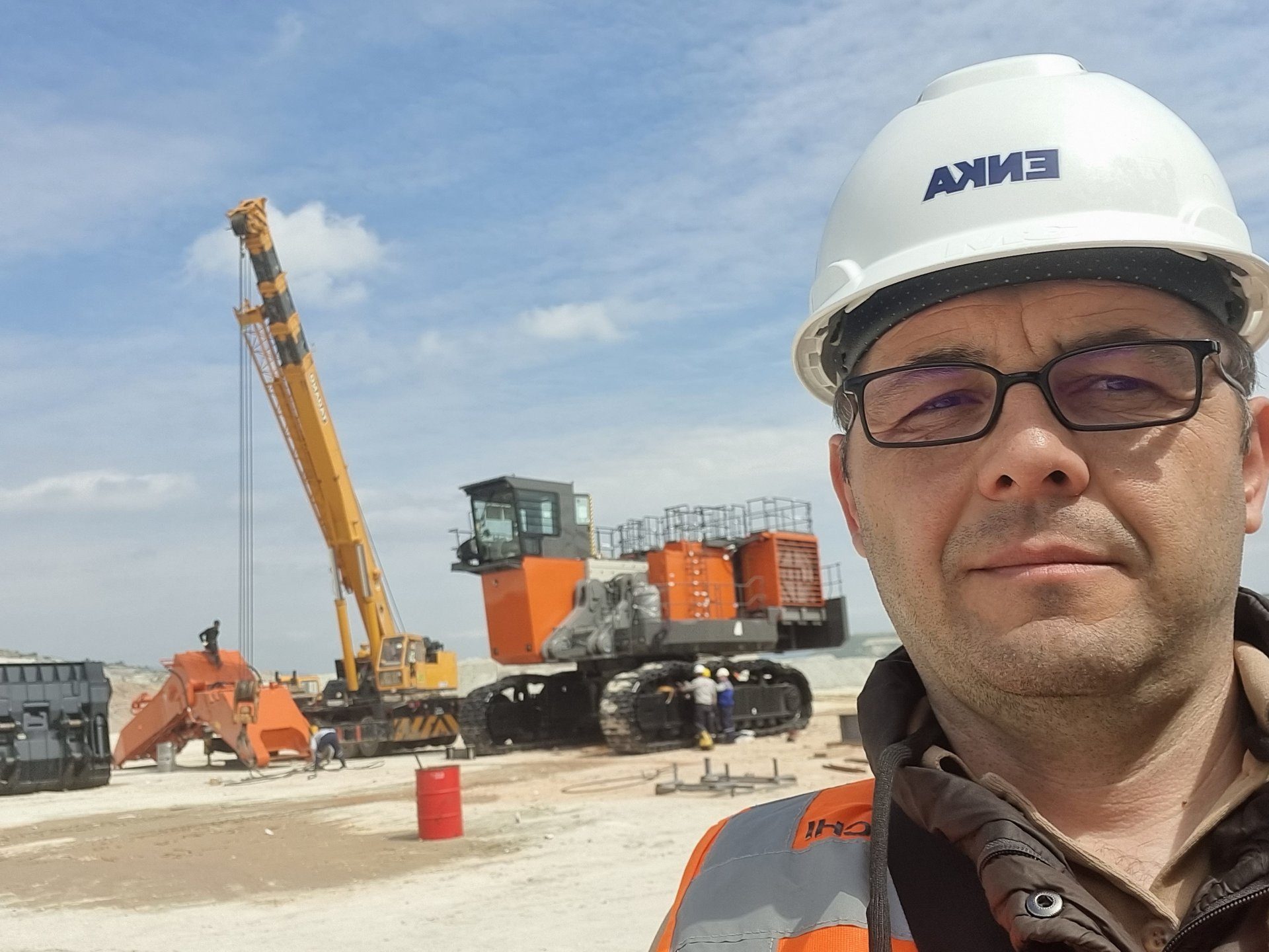 Hard hat, Glasses, Sky, Cloud, Workwear, Vehicle, Asphalt, Helmet, Travel