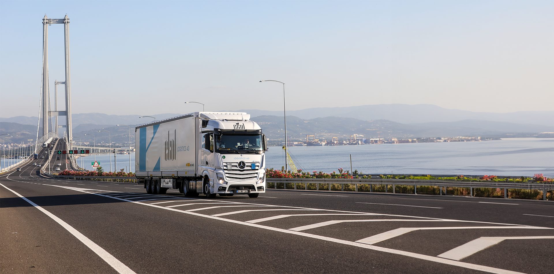 Land vehicle, Road surface, Sky, Tire, Wheel, Truck, Asphalt, Water