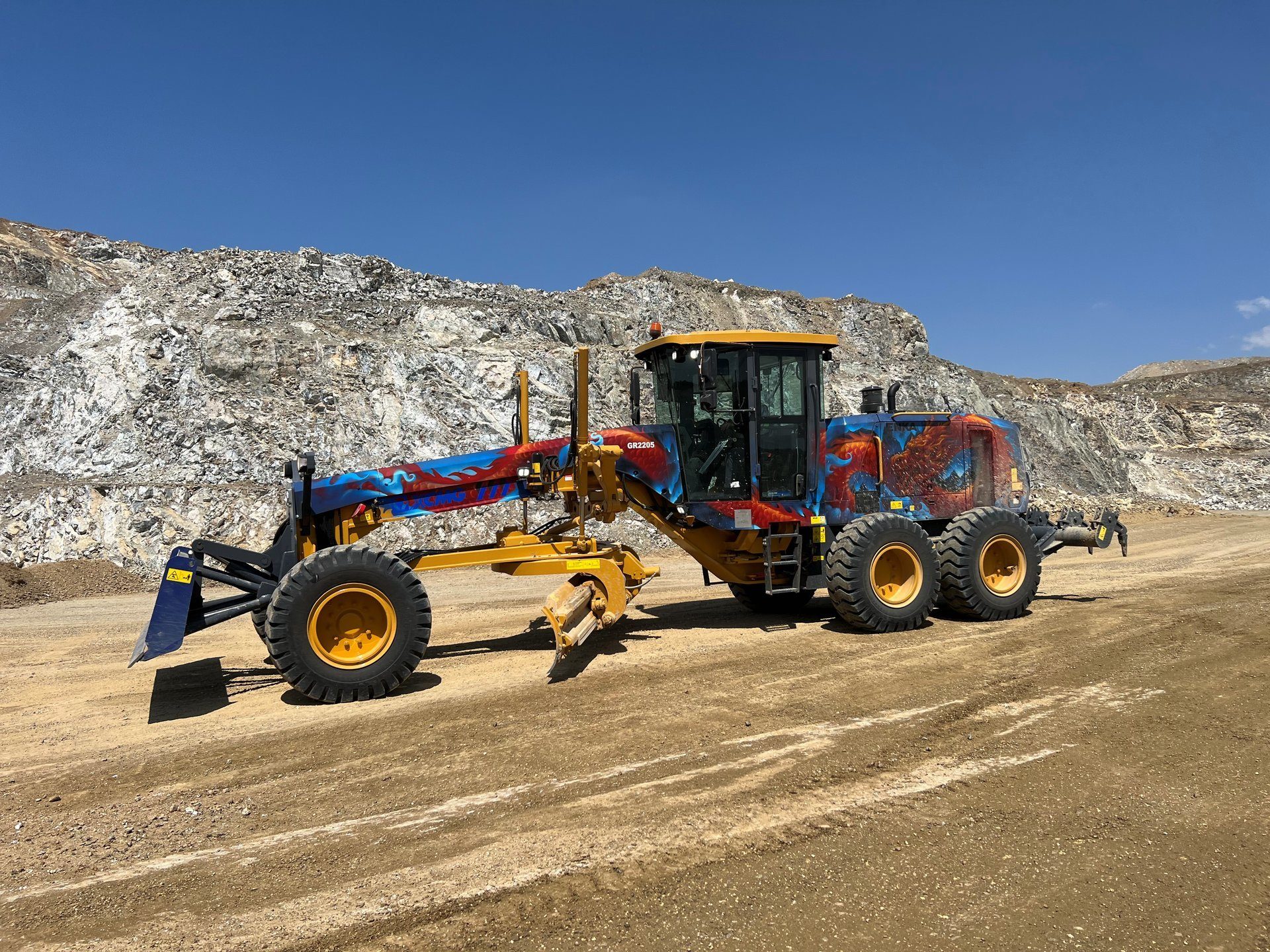 Automotive tire, Motor vehicle, Road surface, Sky, Wheel, Slope, Asphalt, Rolling