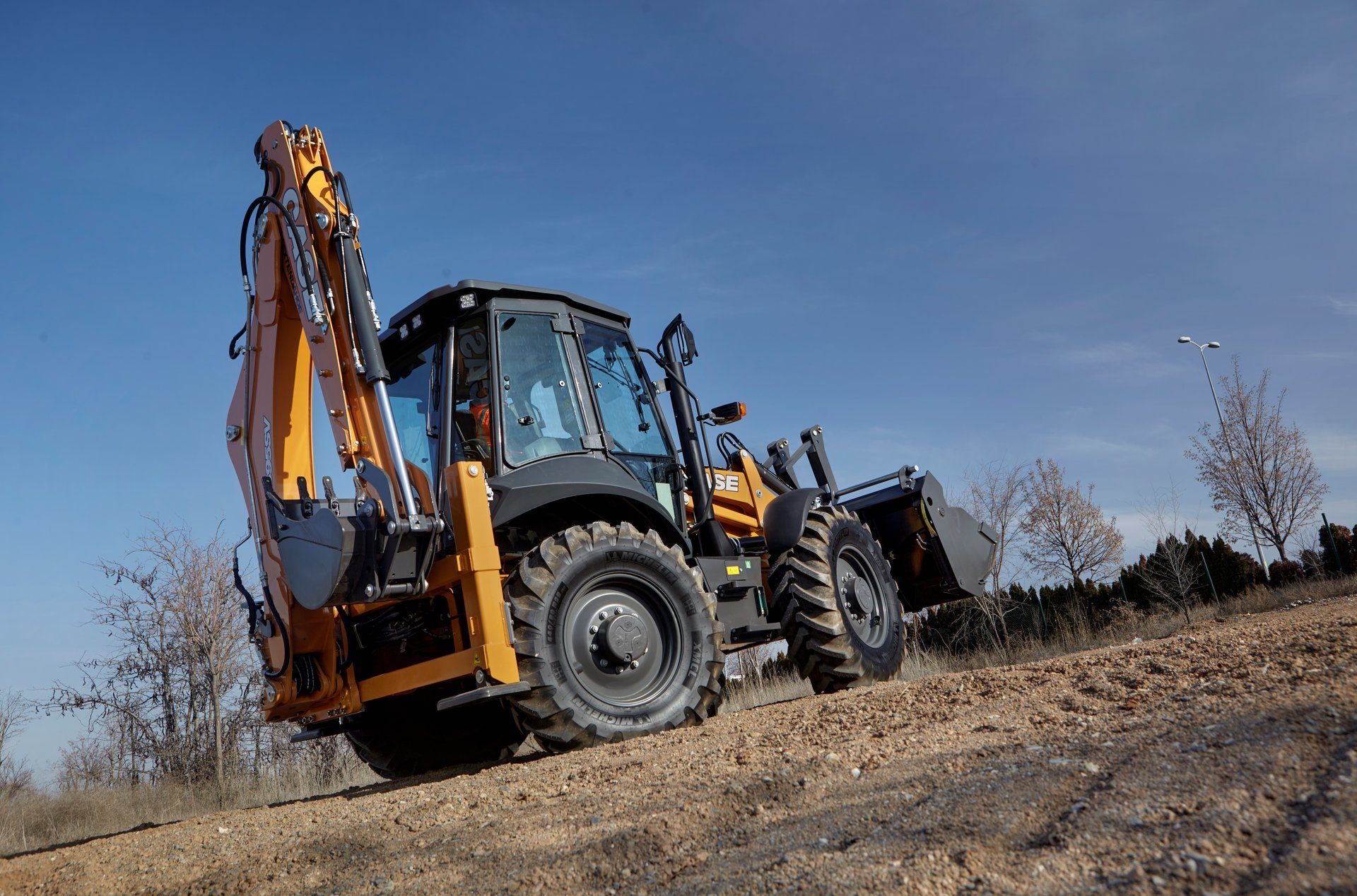 Automotive tire, Motor vehicle, Wheel, Sky, Tractor, Tread, Bulldozer, Asphalt