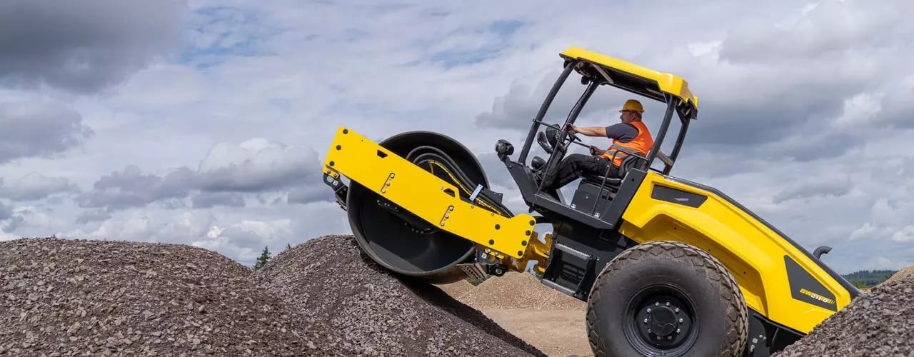 Automotive tire, Motor vehicle, Wheel, Sky, Cloud, Tread, Bulldozer, Asphalt
