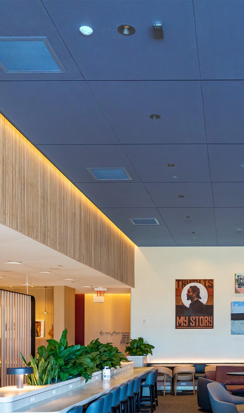 Airport lounge interior with built in lighting and blue ceiling.