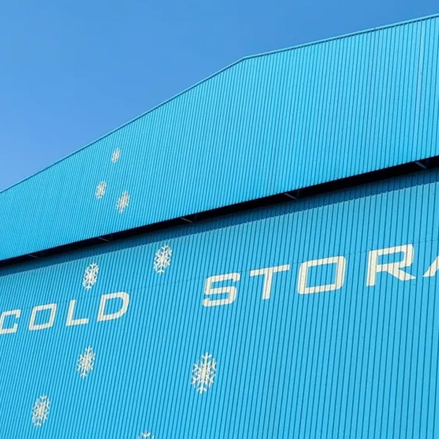 Side of a blue facility marked COLD STORAGE.