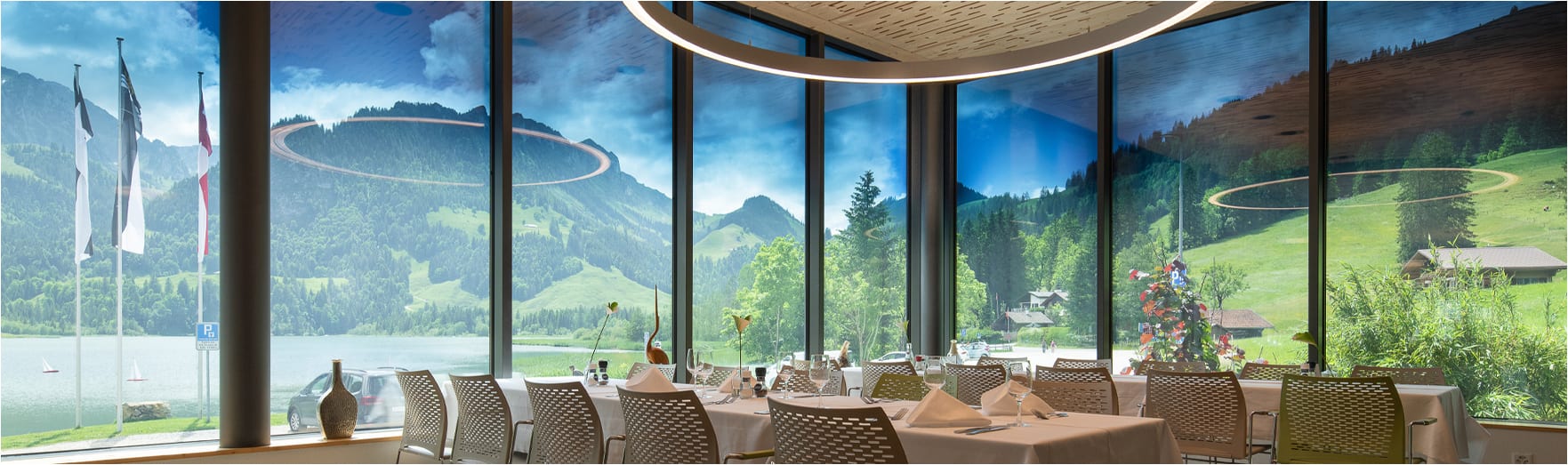 Interior view of a restaurant looking outward  at a beautiful mountain view