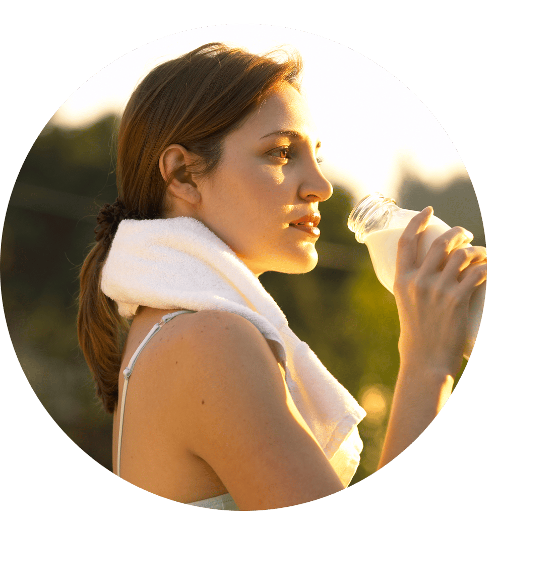 woman outside drinking a bottle of milk during a workout