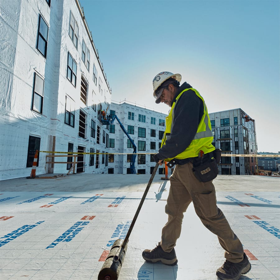 Roofer applying Vapor Barrier