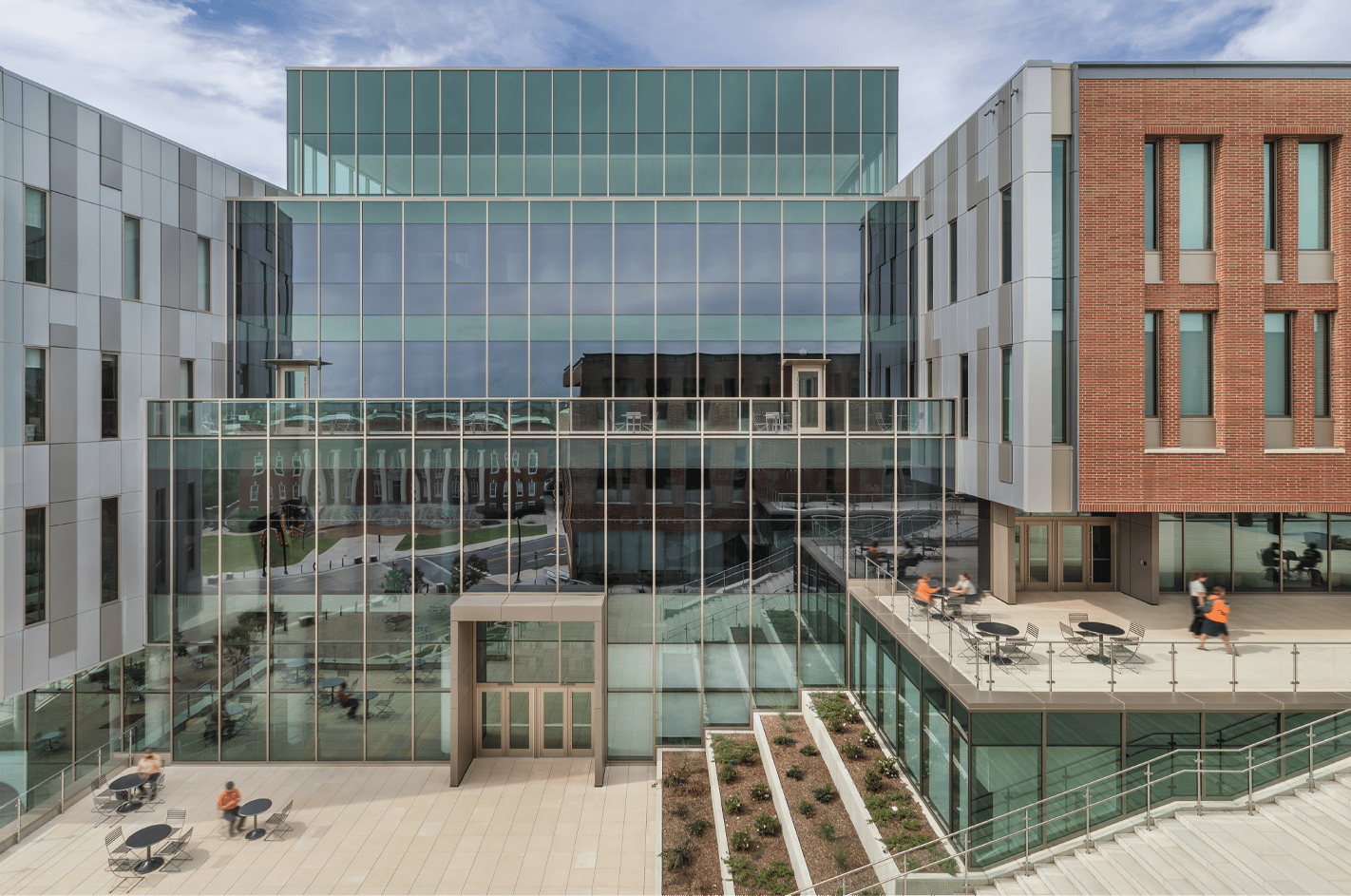 Exterior of a soaring 5-story atrium on a modern university campus