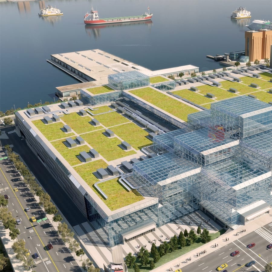 Aerial view of the Javits Center with barge on water in distance.