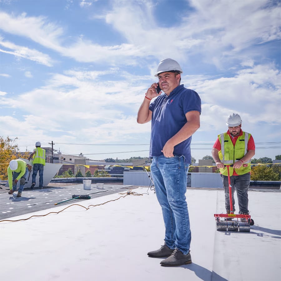 An architect inspects the roof of a commercial building.