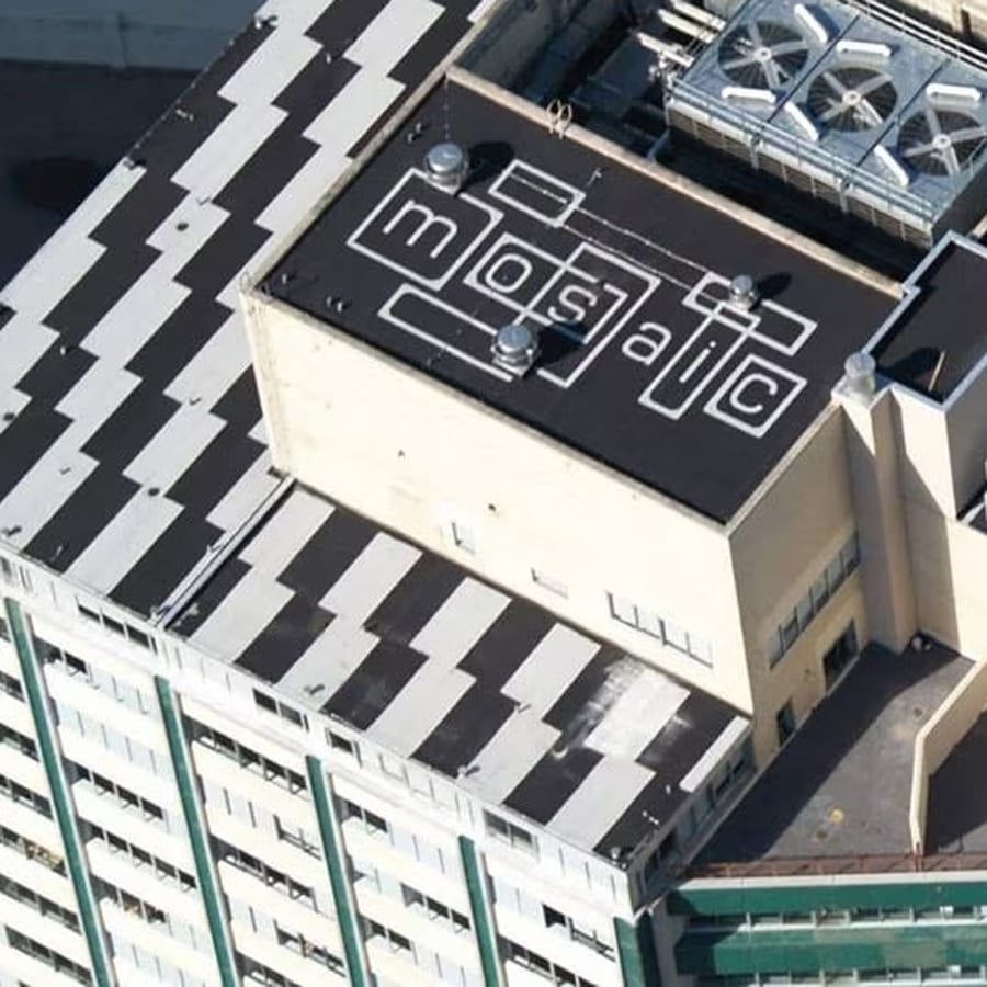 Building roof with 'mosaic' text and black/white zigzag patterns.