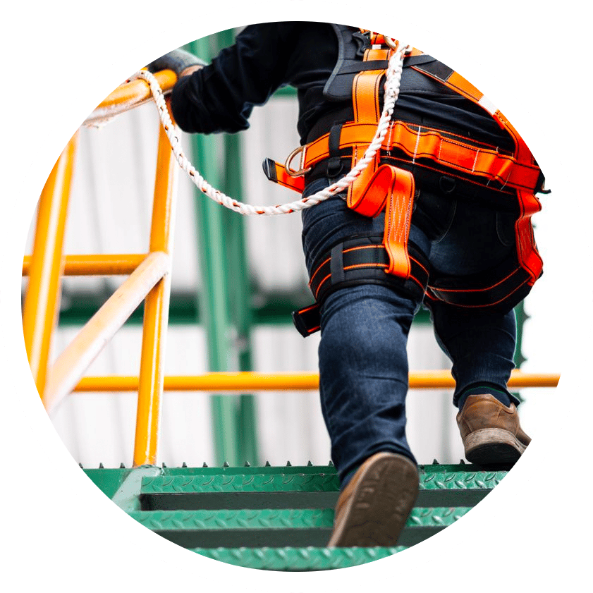 photo of worker in safety climbing gear walking up steps