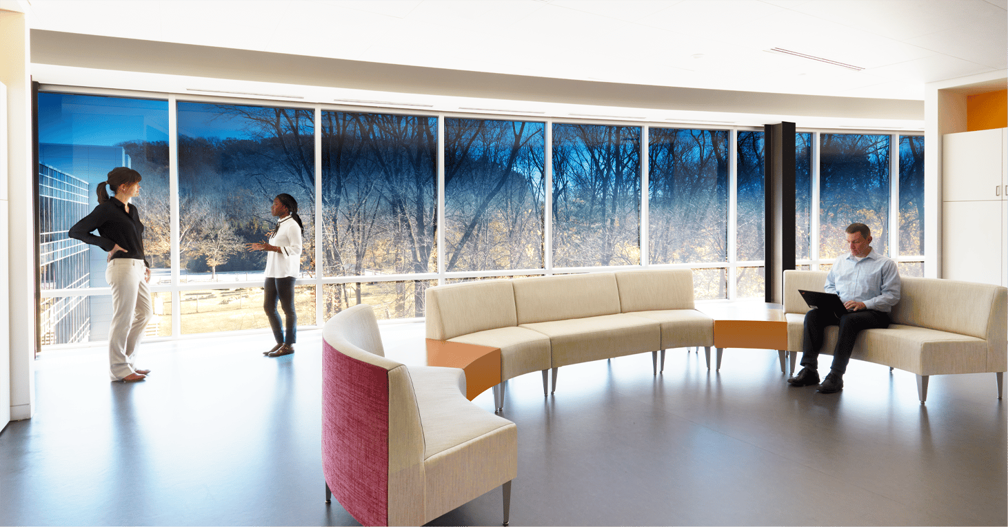 Modern waiting room with a view through tinted windows at a tree filled space