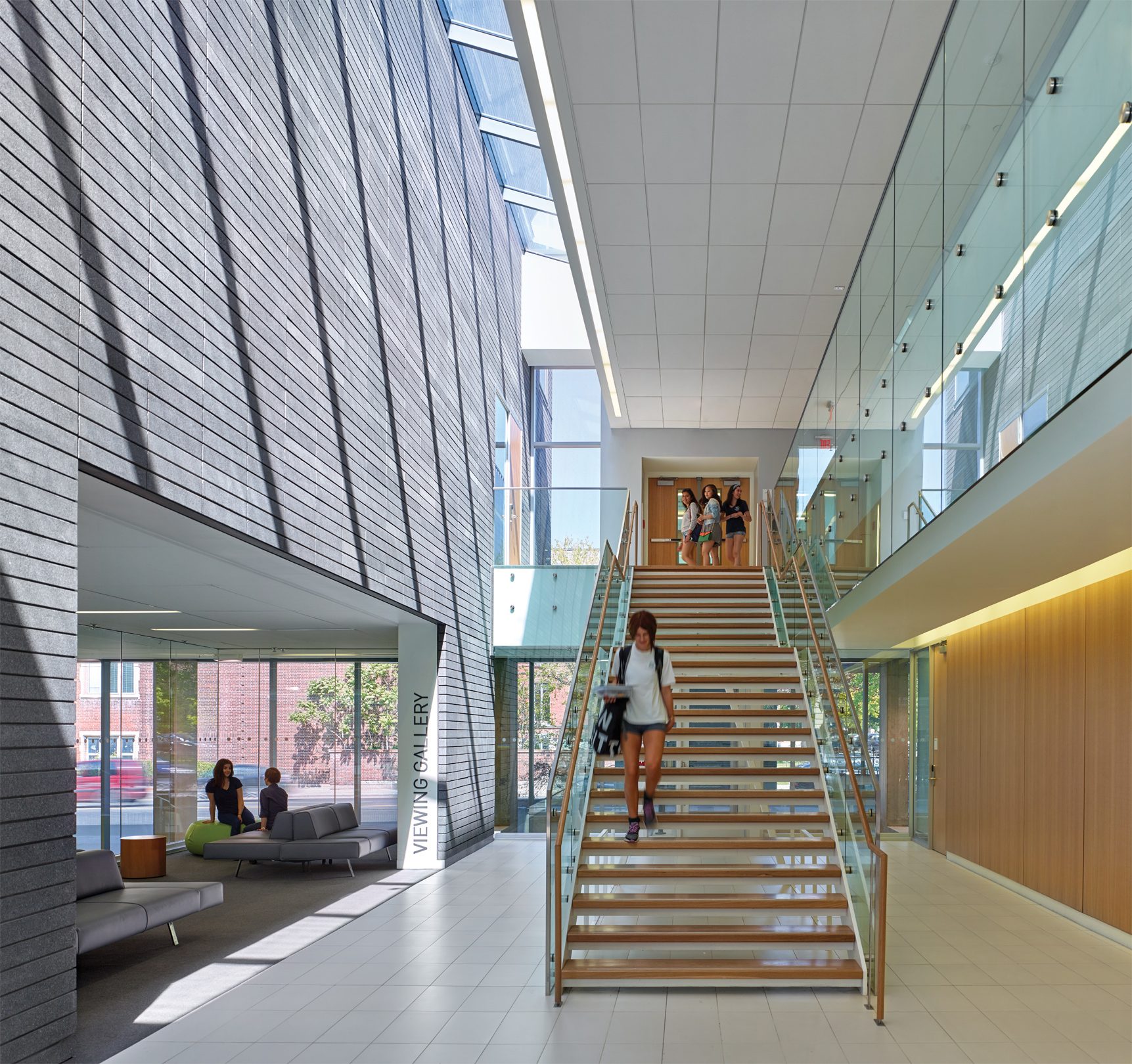 Interior of brightly lit stairway with sunlight and white ceiling system.