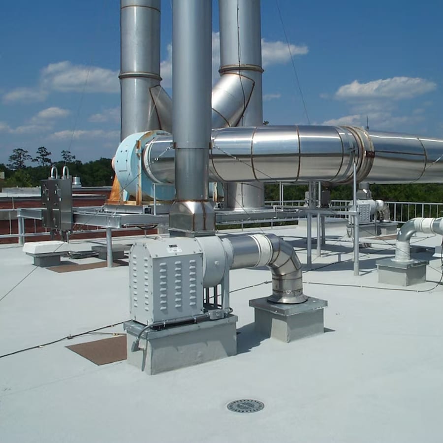 Neat detail of PMMA Roof Membrane in place with other hvac mechanical installation on roof under a blue sky.