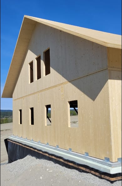 CLT building under construction, side view with windows.