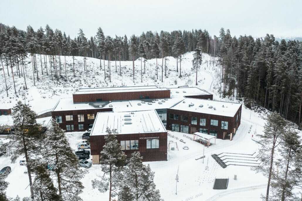 Hov Ungdomsskole, a snow-covered school in a winter forest.