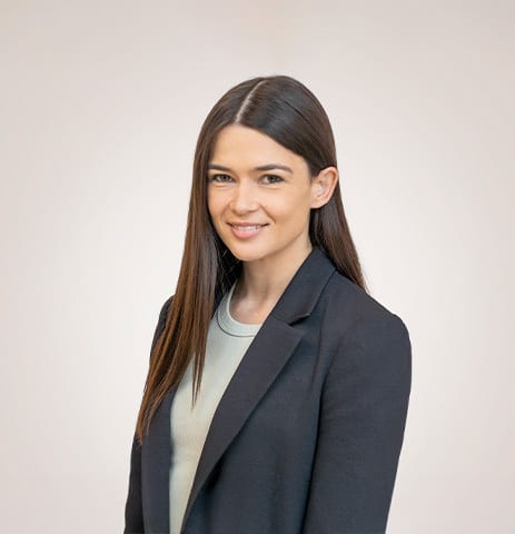 Smiling professional woman with dark hair in a blazer.