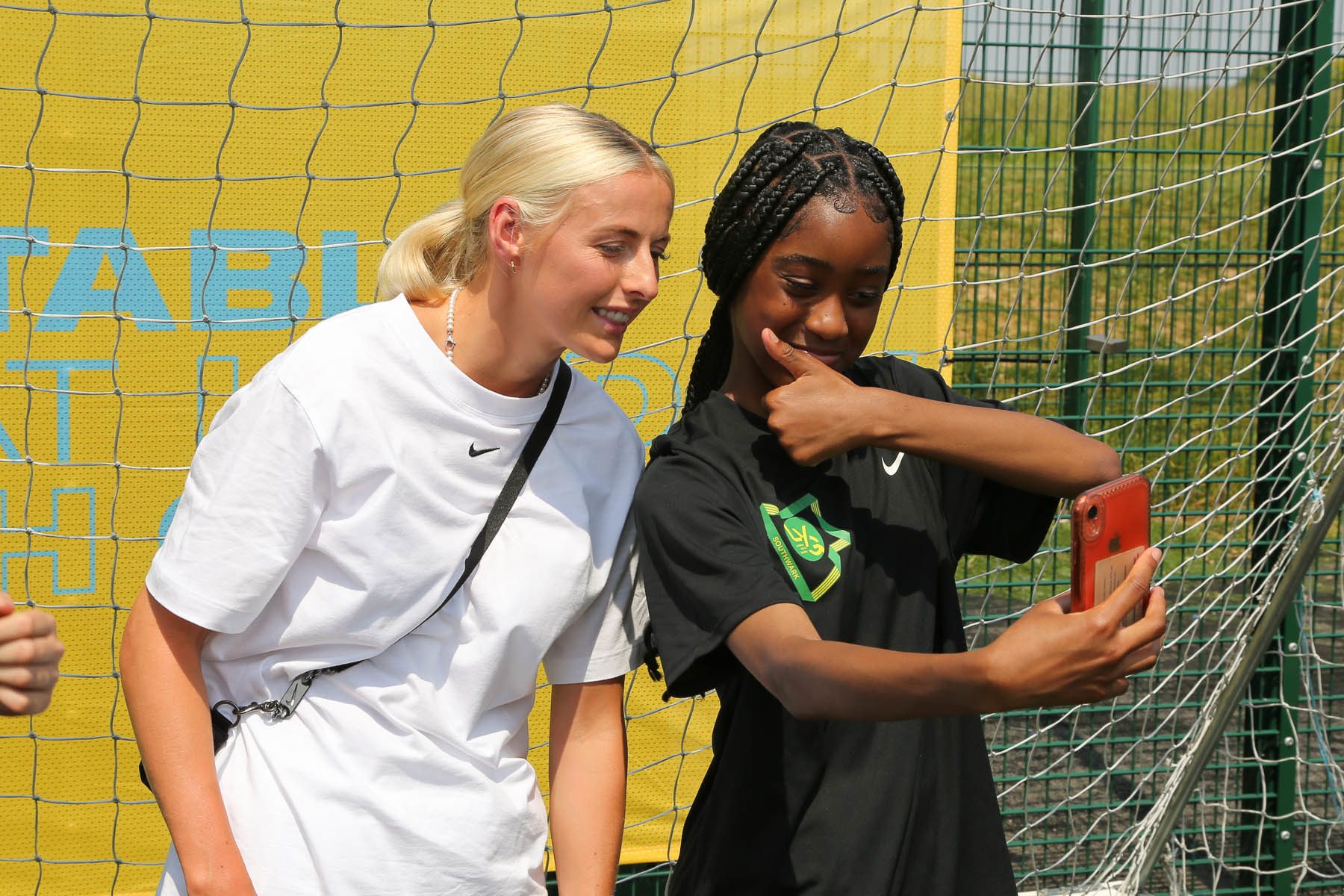 Chloe Kelly taking a photo with a black girl