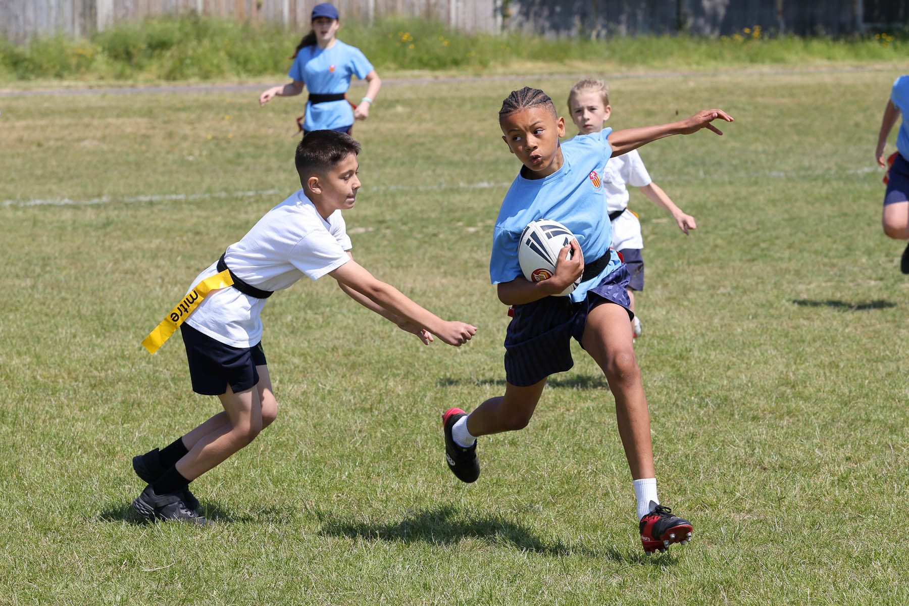 2 boys playing tag rugby