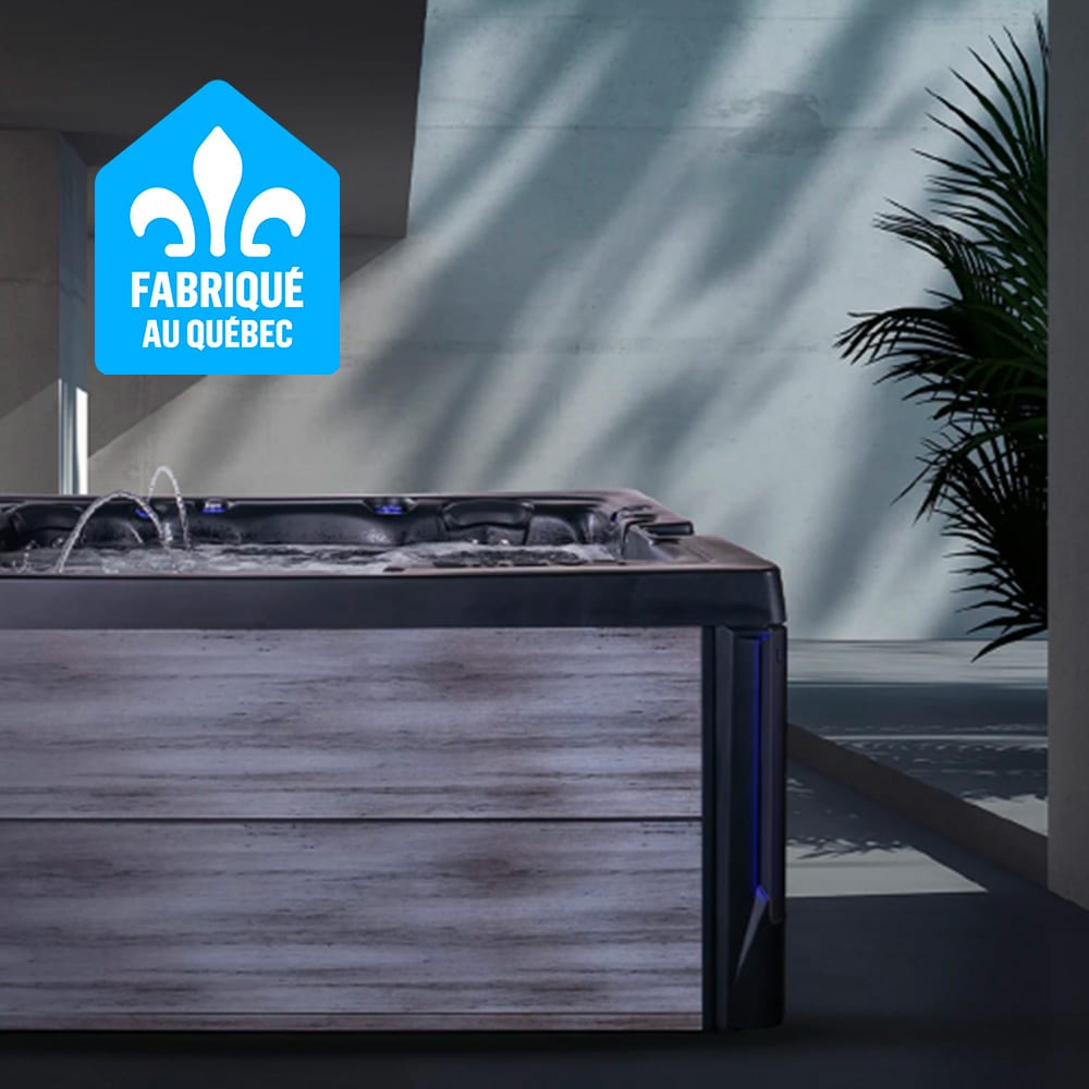 Quebec-made spa with water jets, blue lights, and a plant in a modern setting.