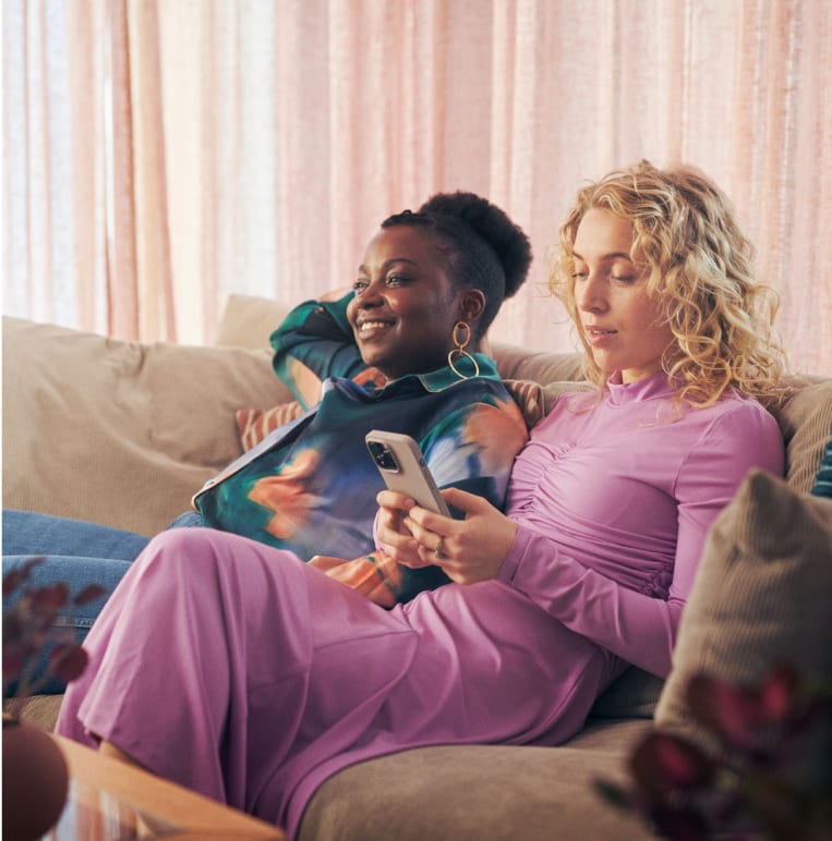 Facial expression, Face, Smile, Arm, Comfort, Purple, Curtain, Happy, Gesture, Couch