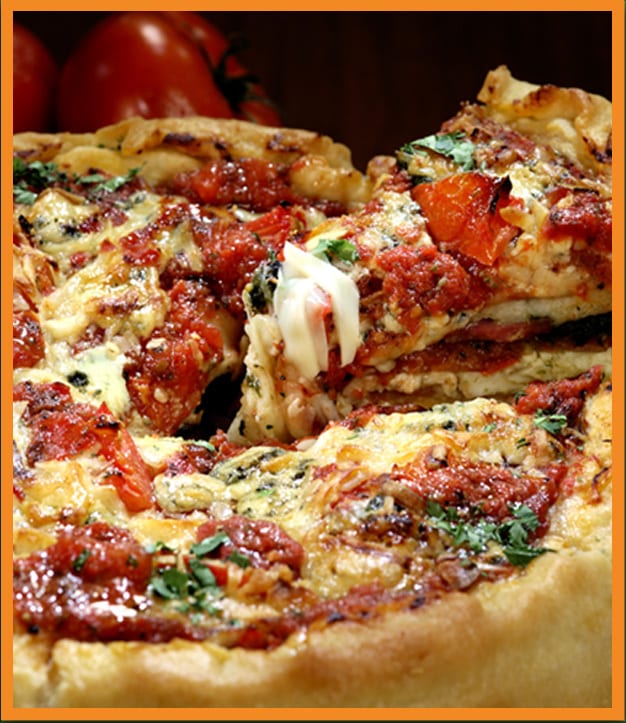 Deep-dish pizza with a slice being lifted, showing melted cheese, tomato sauce, and herbs.