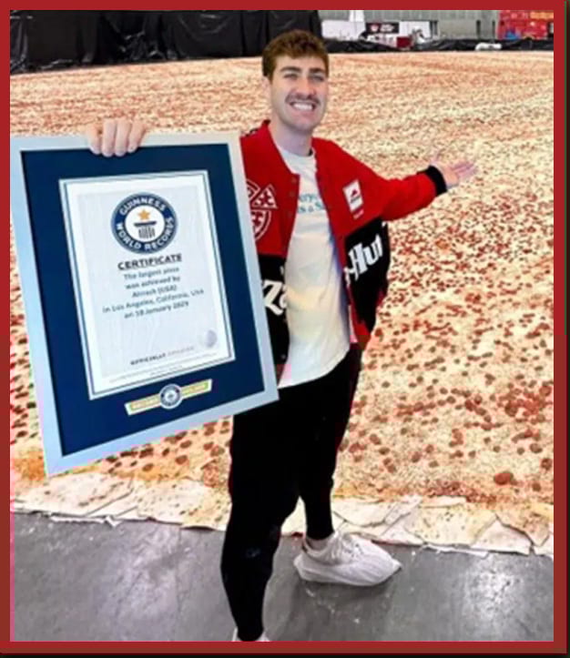 Airrack holds a Guinness World Record certificate for the largest pizza, standing in front of it.
