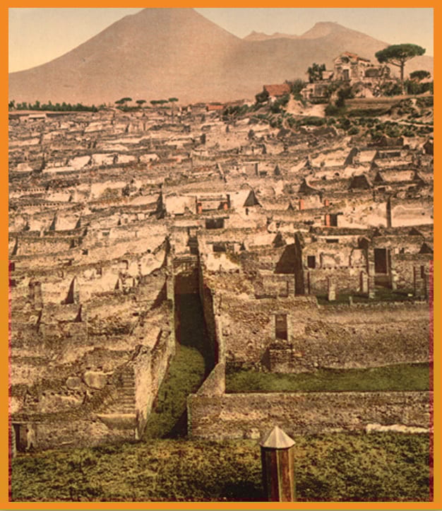Ancient ruins of Pompeii with Mount Vesuvius looming behind.