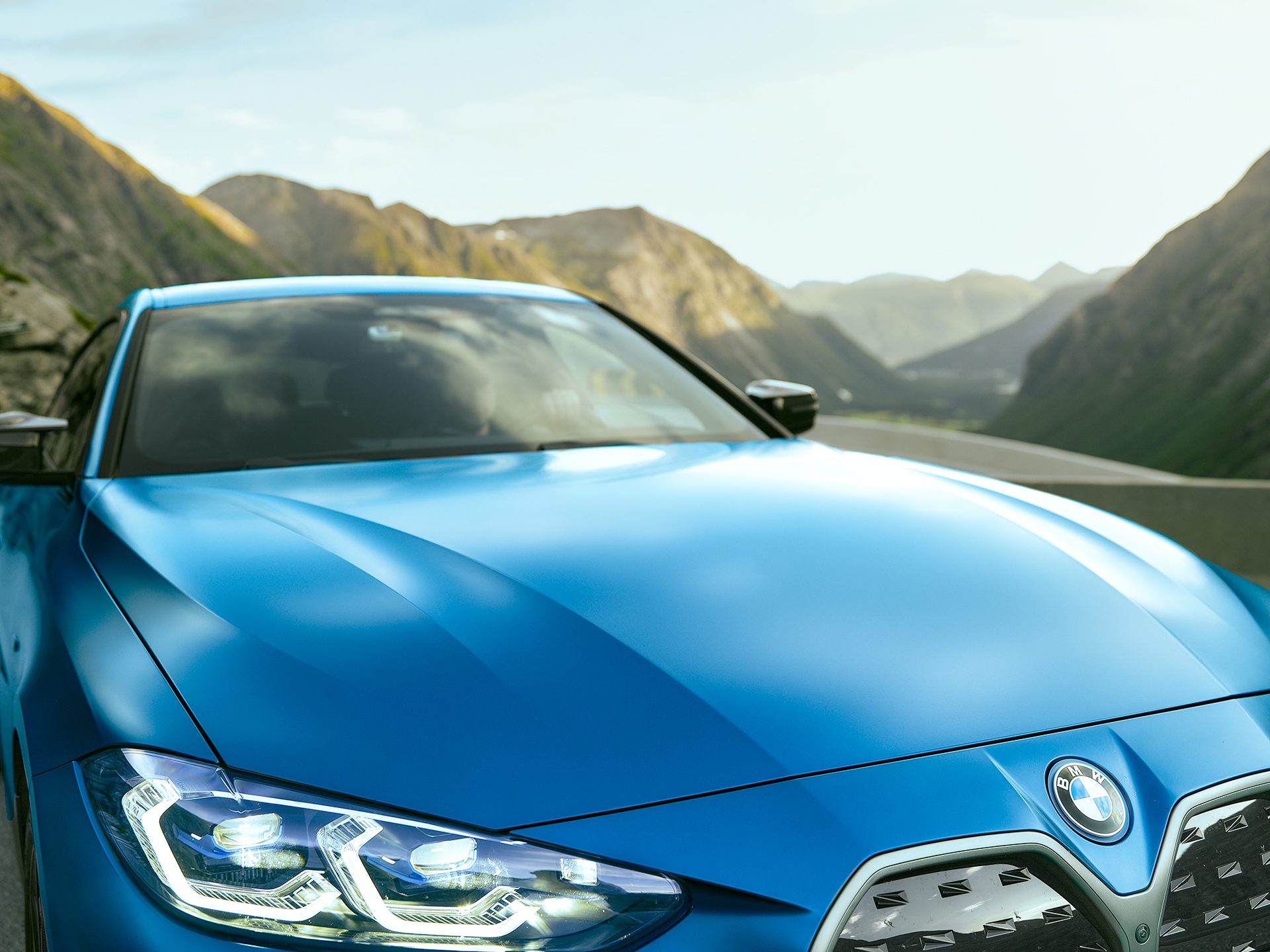 Automotive lighting, Motor vehicle, Sky, Car, Mountain, Grille, Hood, Blue